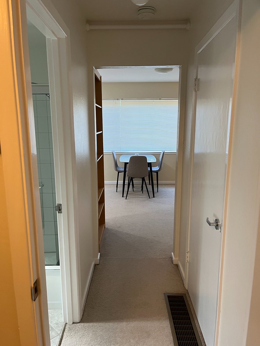 View of kitchen/dining table from bedroom / hallway.