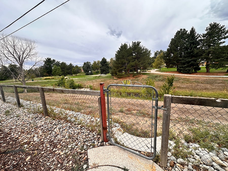 Fenced yard with gate access to creek and Little Dry Creek Park and paths.
