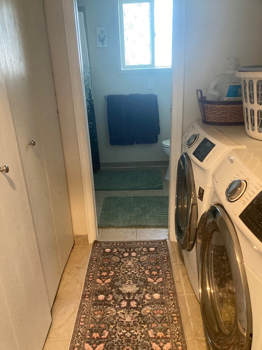 Washer and dryer (shared) in hallway before bathroom