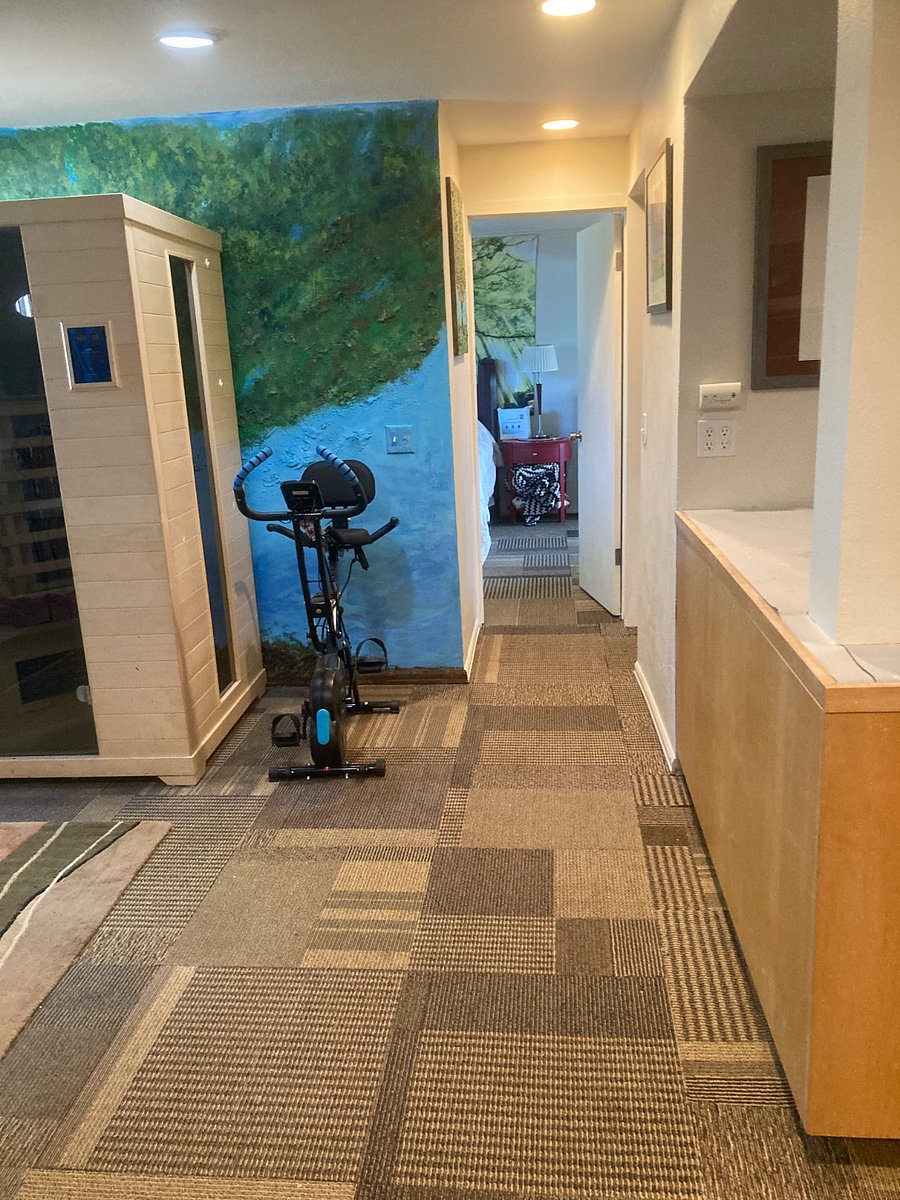 Hallway from living area and sauna, exercise bike and bistro eating area to bathroom and bedroom