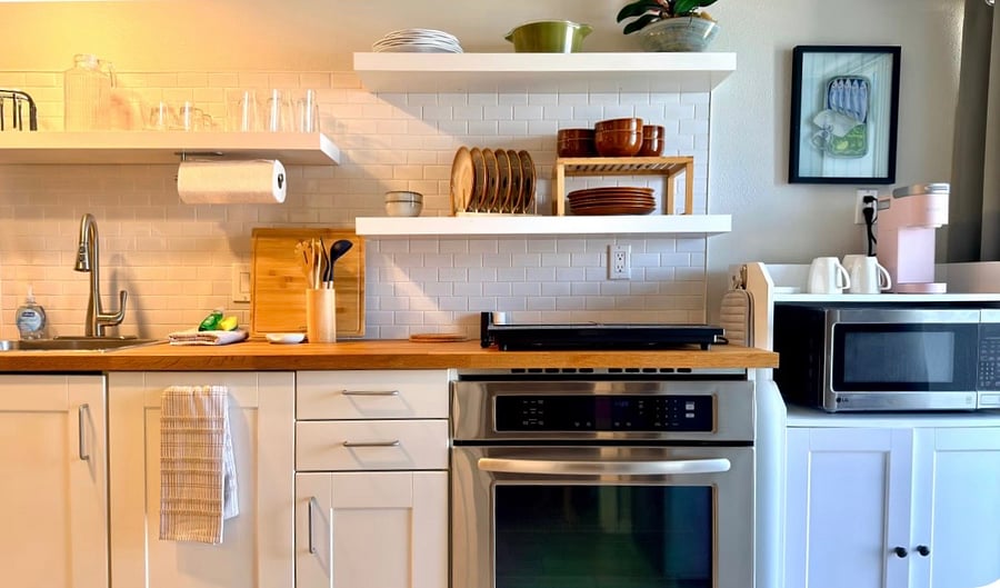 Kitchen, fully stocked with 2 burner induction stove and full size oven.