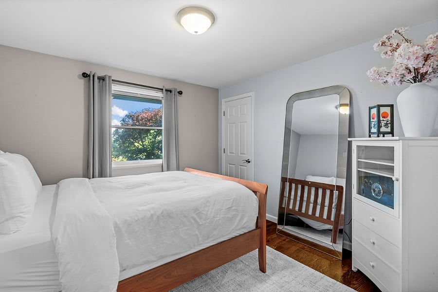 The primary level guest bedroom features a comfortable queen size bed.  