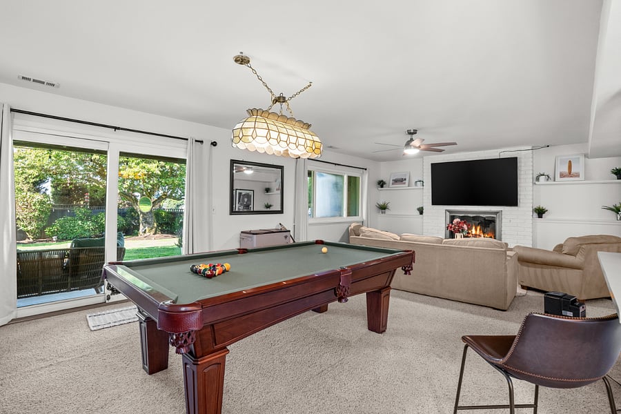 The lower level features a spacious living room combined with a fun and inviting game room. 