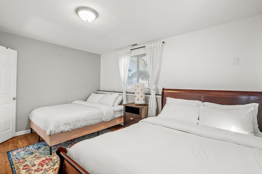 The spacious lower level bedroom features two comfortable queen size beds. 