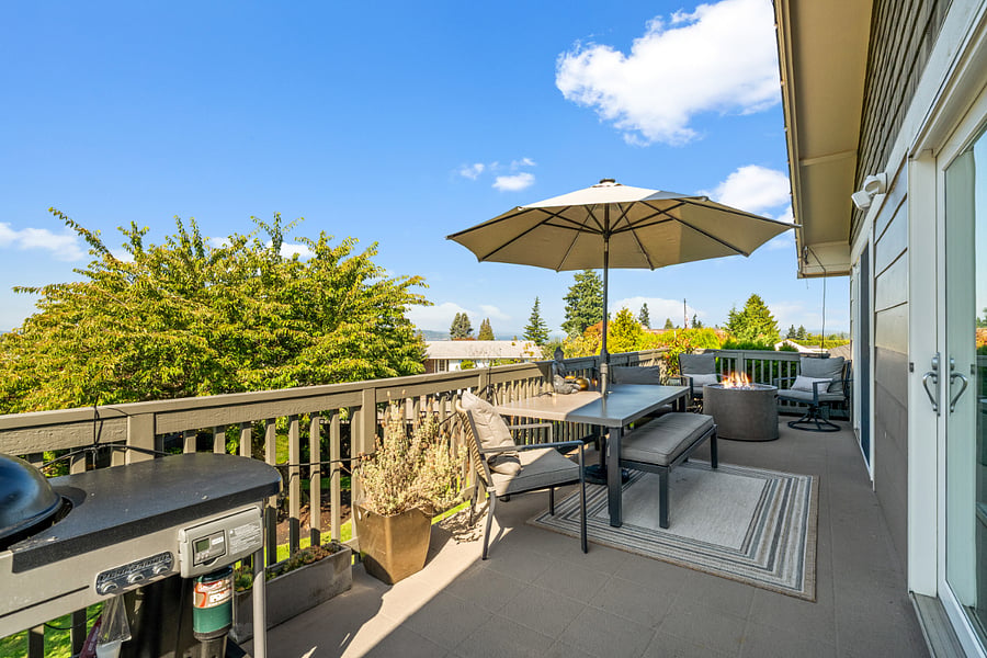 Enjoy the primary level balcony, complete with comfortable outdoor furniture, a fire pit and a grill.
