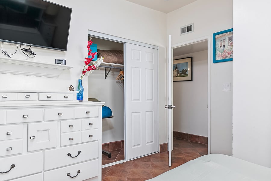 Bedroom 4 (Green Room): A bright fourth bedroom with a window, ceiling fan, and comfortable sleeping space