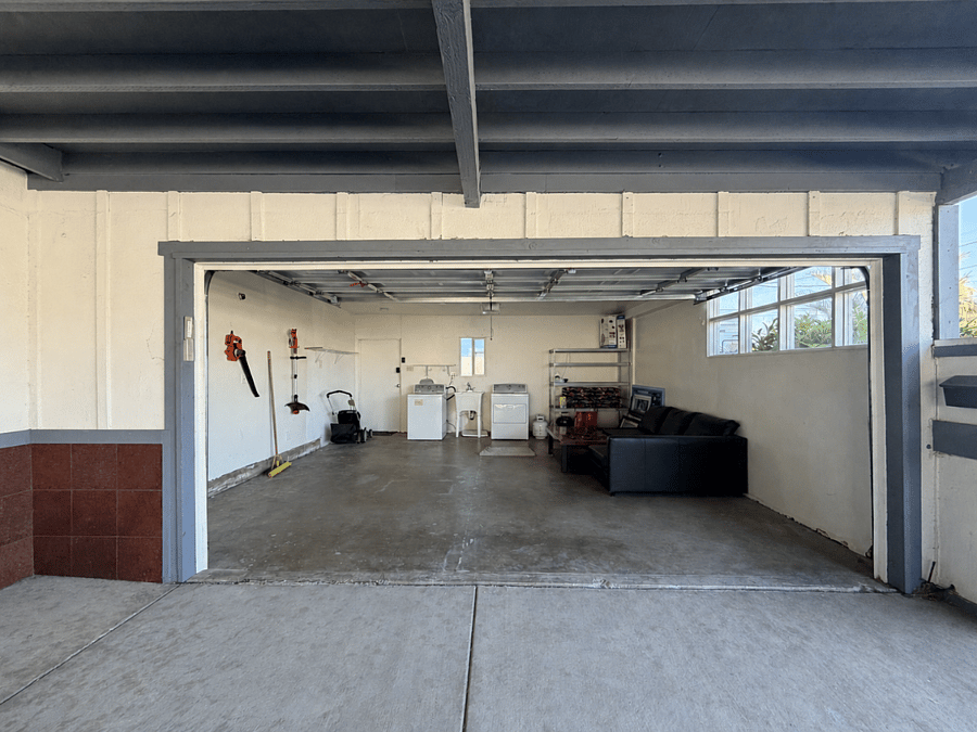 The garage adds practical utility with laundry facilities, shelving, and room for vehicles or projects