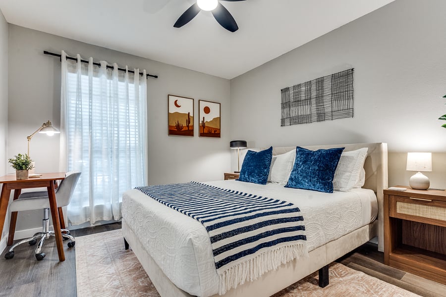 Tranquil master bedroom featuring a plush queen-size bed and work area