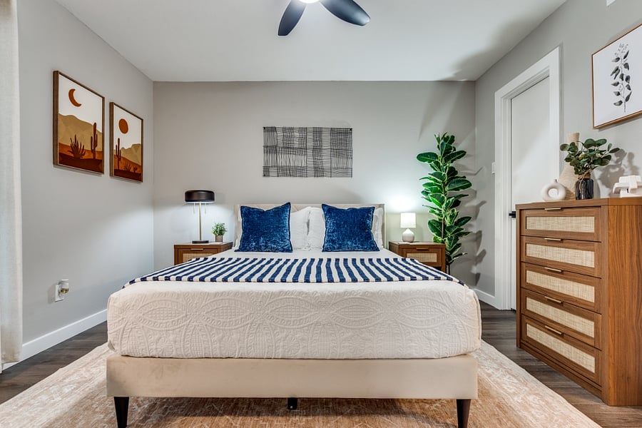Cozy bedroom angle showing natural lighting, ample closet space, and decor