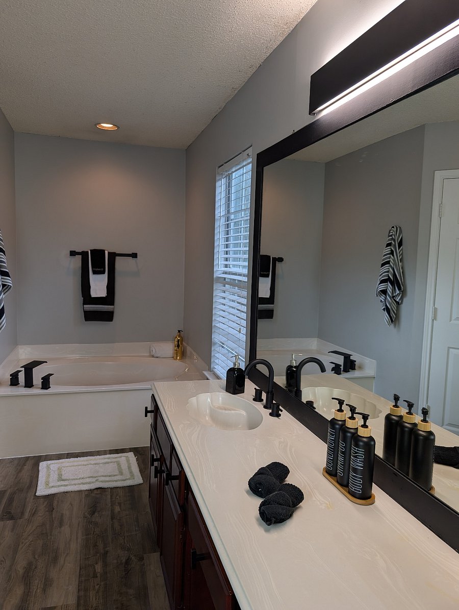 Primary Bathroom with a soaker tub, walk in shower and dual sink vanity with a vanity desk.