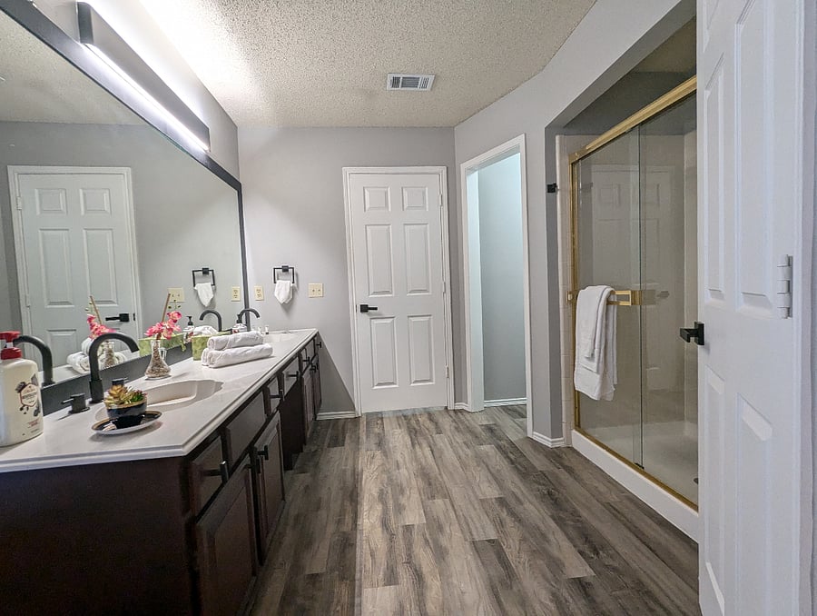 Primary Bathroom with a soaker tub, walk in shower and dual sink vanity with a vanity desk.