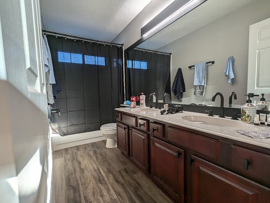 Second full bathroom with a bathtub/shower combo and two sinks.