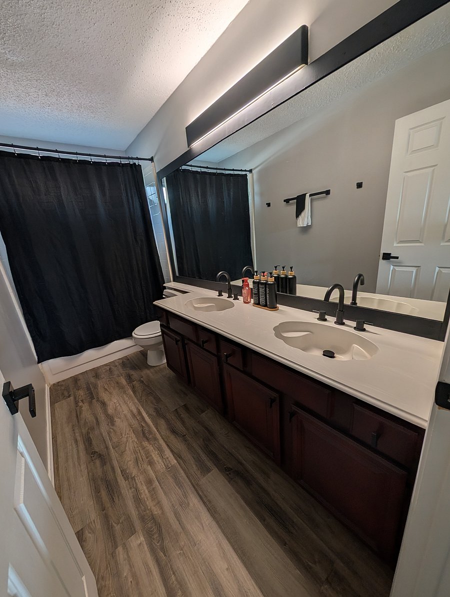 Second full bathroom with a bathtub/shower combo and two sinks.