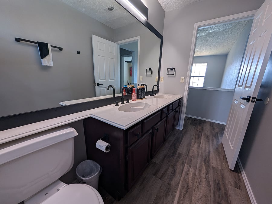Second full bathroom with a bathtub/shower combo and two sinks.