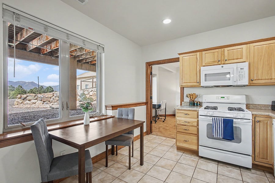 Inviting eat-in kitchen with comfortable dining space, abundant natural light, and beautiful mountain views the perfect spot to enjoy your morning coffee or a relaxed meal.
