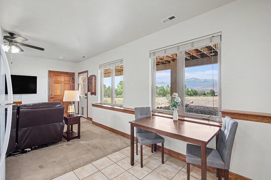 Sunlit dining area with mountain views, situated beside the open-concept living room and offering the perfect setting for meals, morning coffee, or working remotely.