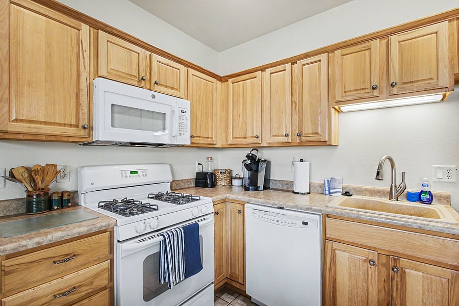 Generous cabinetry, ample counter space, a coffee maker, cookware, and everyday essentials make preparing meals easy and convenient.