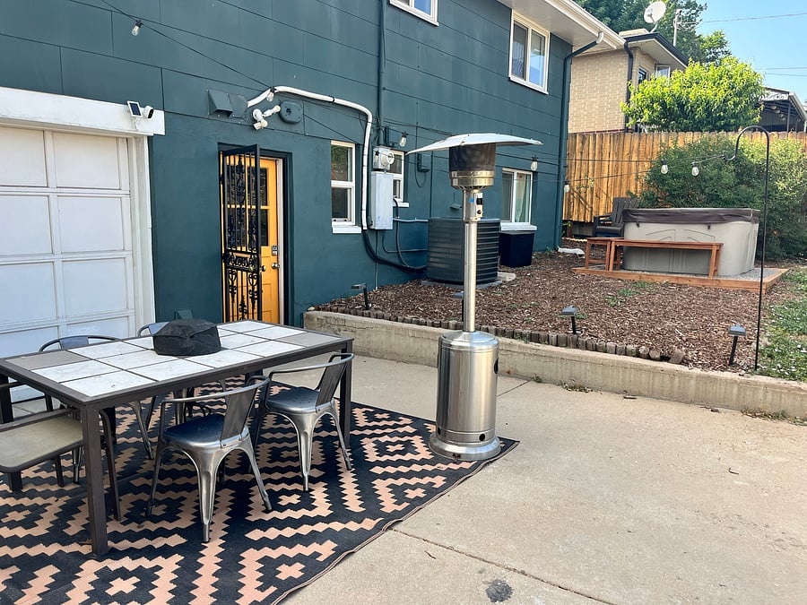 Outdoor dining area, private entrance to lower unit, and hot tub