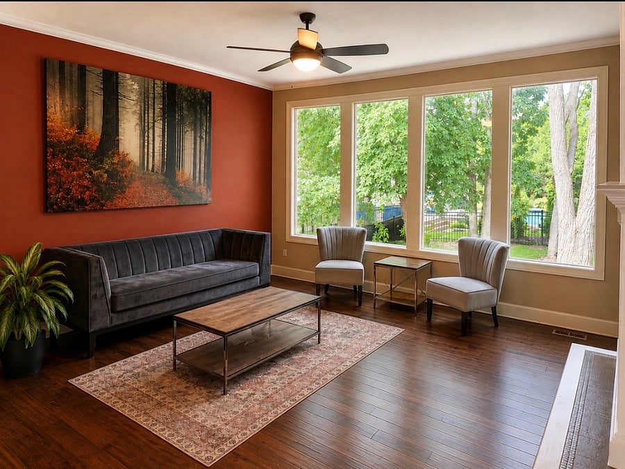 Living room, on the other side of the kitchen/fireplace. Large picturesque windows.