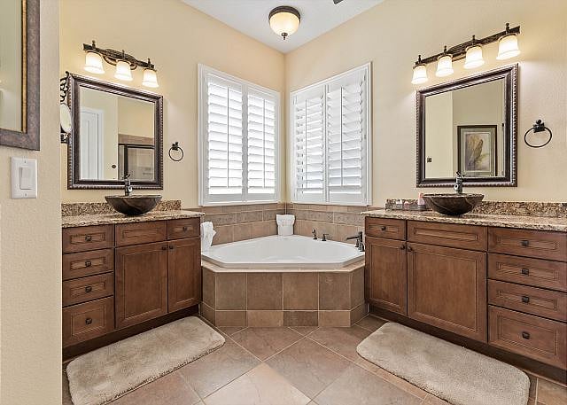 Spacious primary suite bathroom with soaking tub, shower and dual sinks