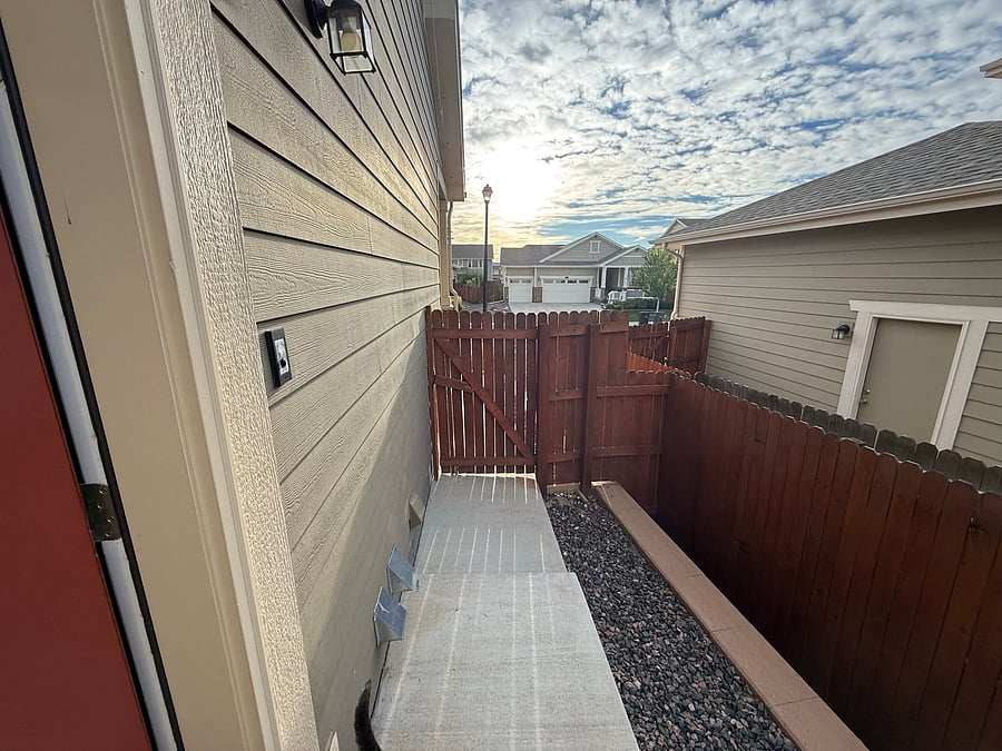 Entrance is behind a privacy fence