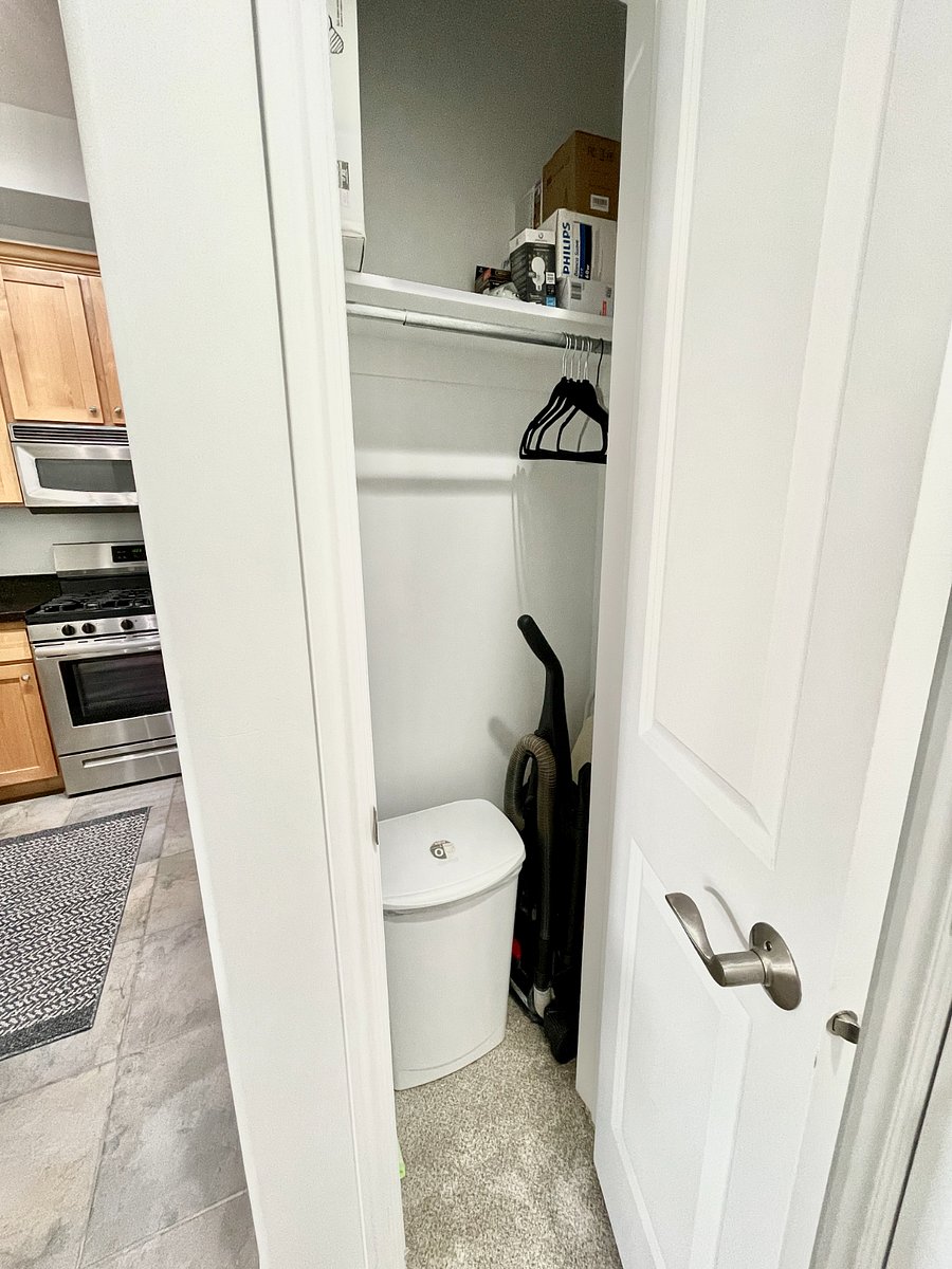 Entry closet with cleaning supplies, vacuum, iron/ironing board