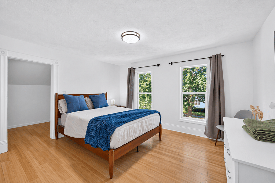 Primary bedroom, queen bed, blackout curtains, and sound machine