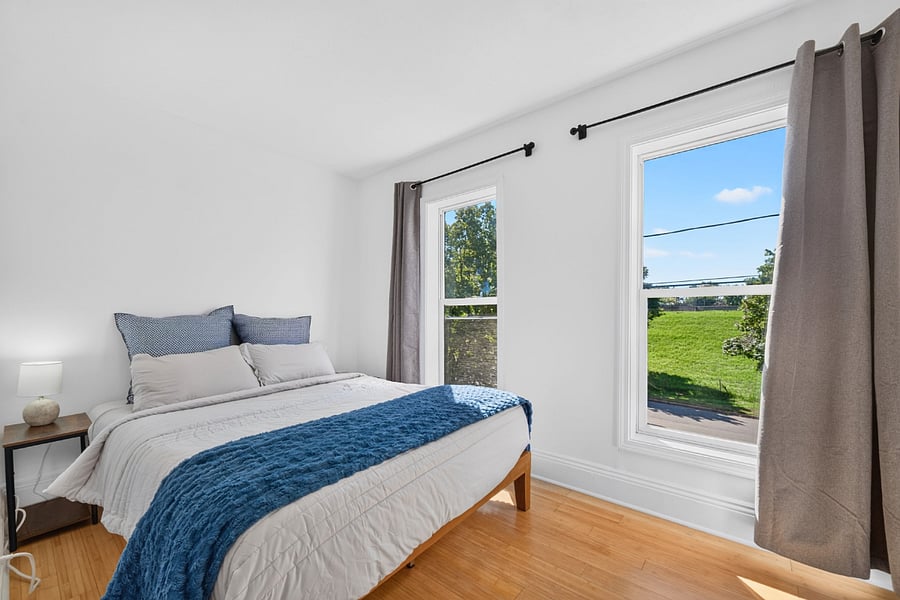Second bedroom with blackout curtains and views outside