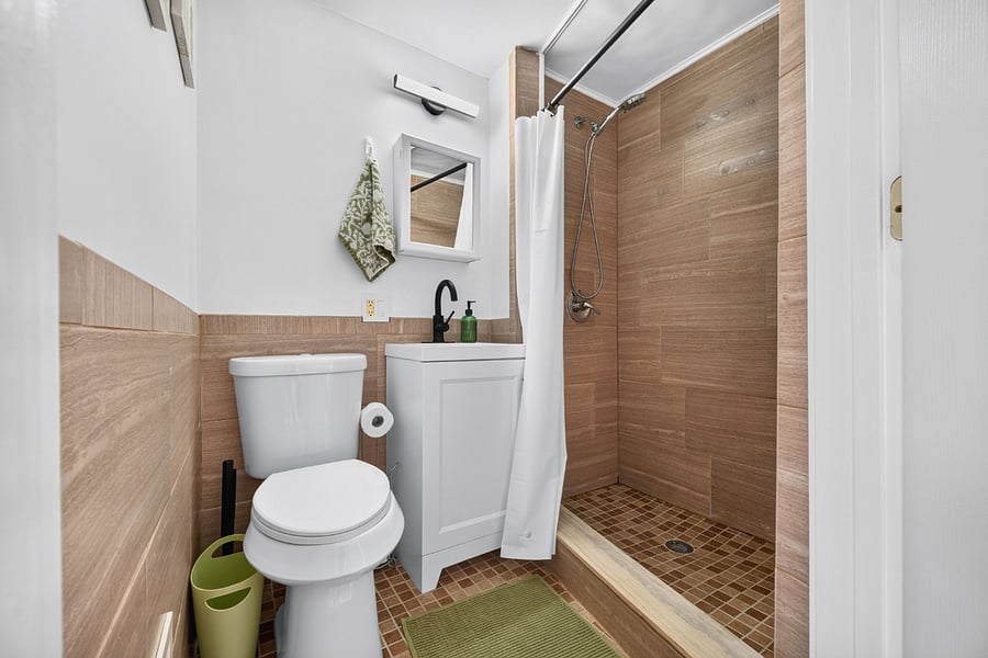 Full bathroom with walk-in tile shower
