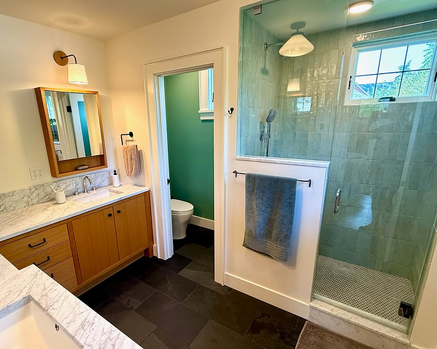 Primary suite bathroom features 2 sinks and privacy WC