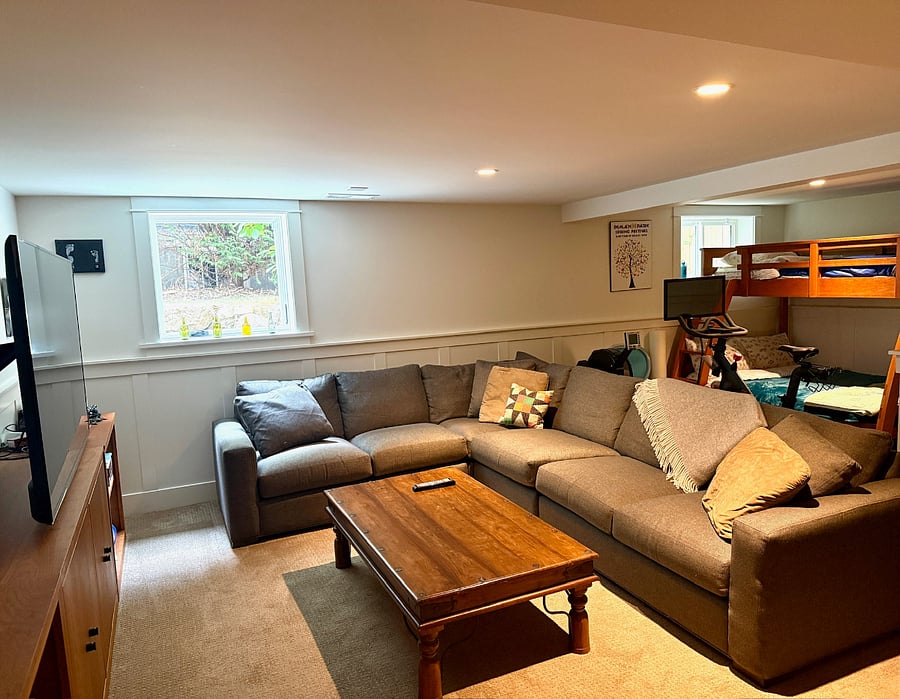 Rec room in fully finished basement features twin-over-full bunkbed