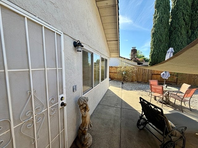 Private entrance to backyard patio and gate around the corner opens to driveway