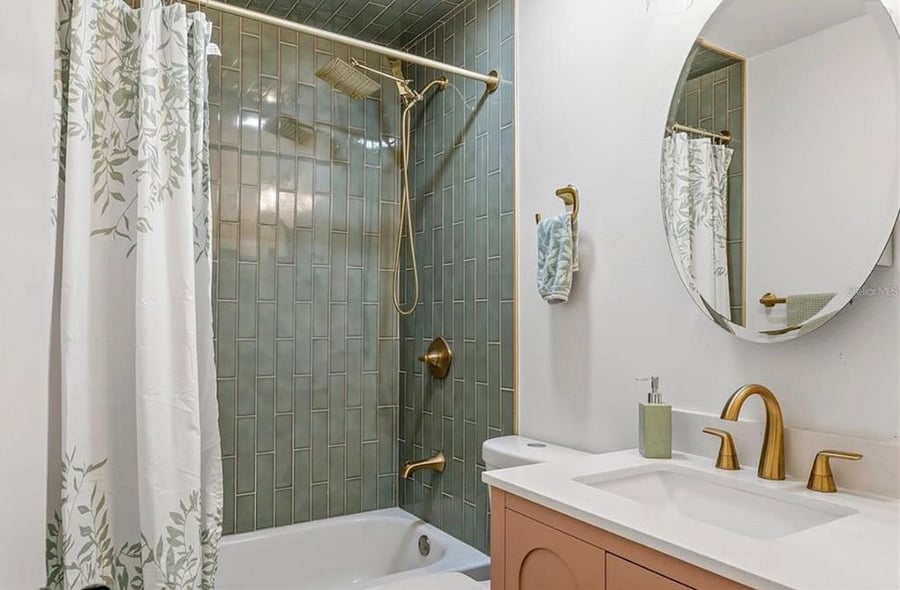 Pink and Green Shared Bathroom with a Tub