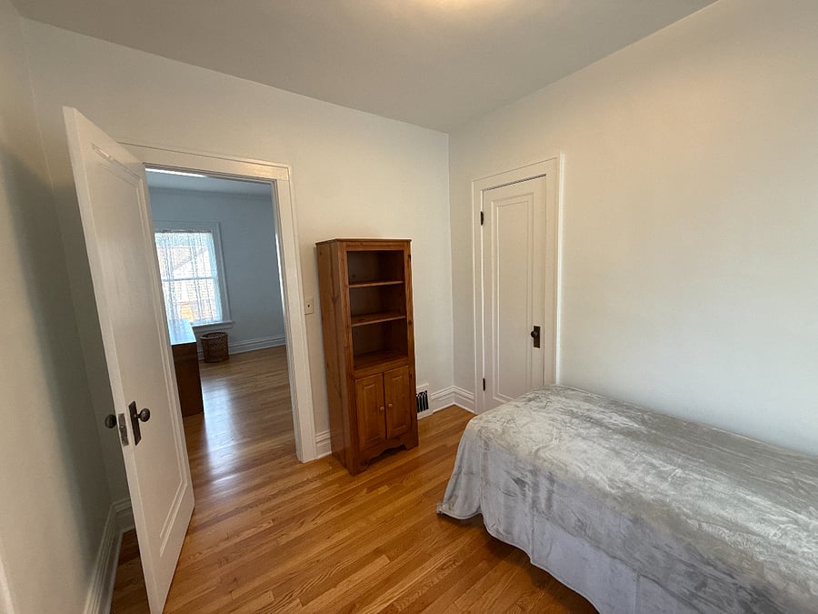 Bedroom Three, soon to have blackout curtains. Currently hosts a twin mattress and a desk. This can be easily rearranged into an office or study.