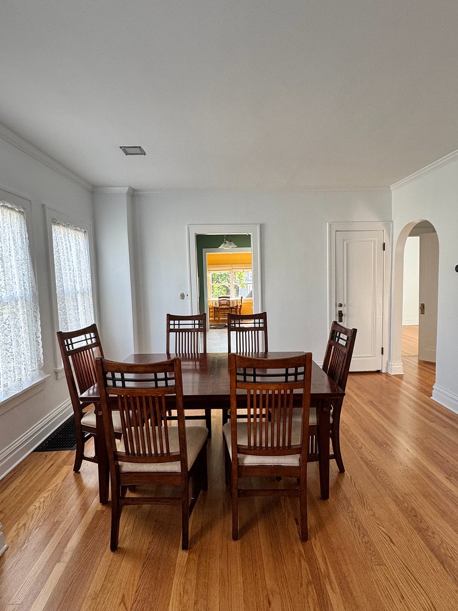 The Dining room is open and full of diffuse light from the north through the many large windows and tall ceilings. It makes it a great space to gather. 