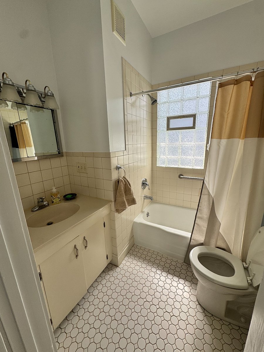 the full bath is centrally located hosting a shower and tub. 