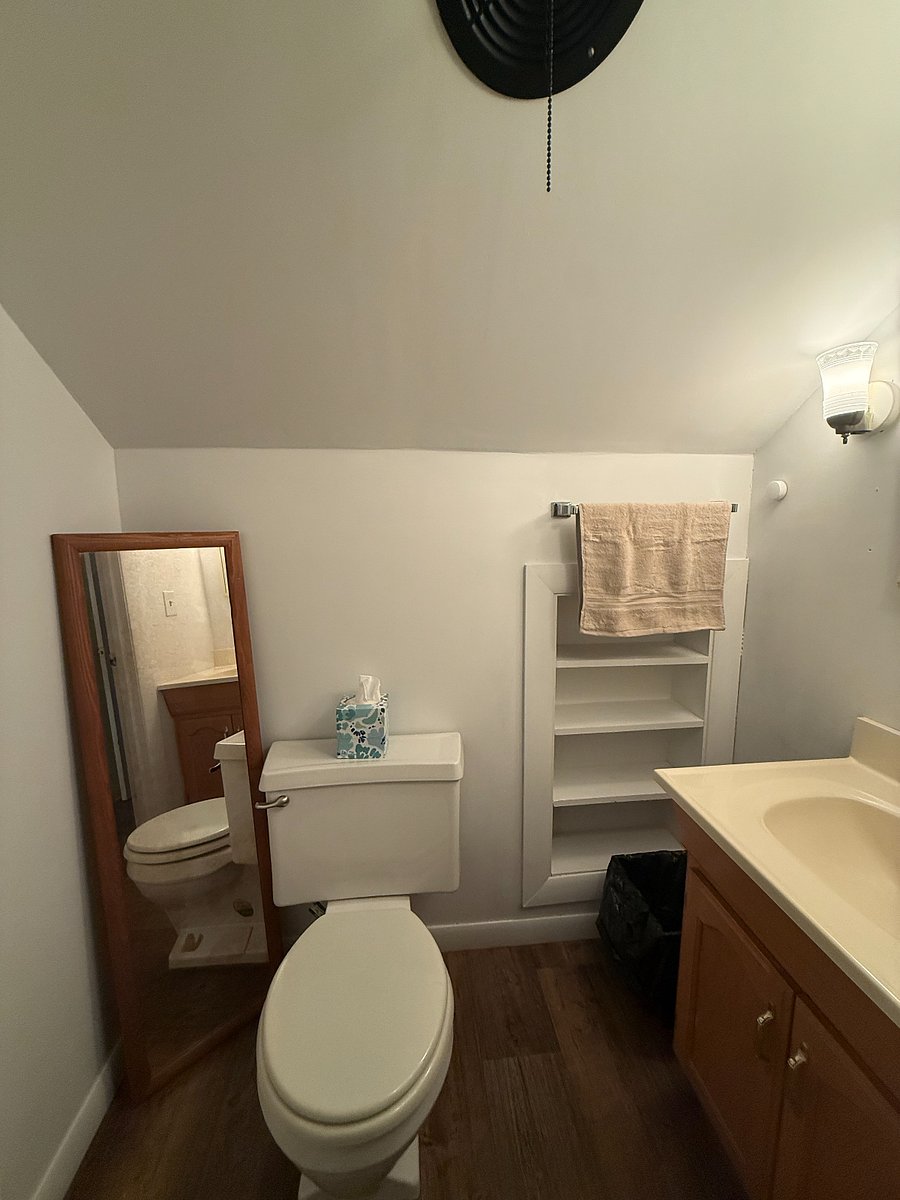 This is the half-bath upstairs next to the bedroom. The vintage toil was rebuilt instead of replaced to keep the tailored feel of the house intact.  