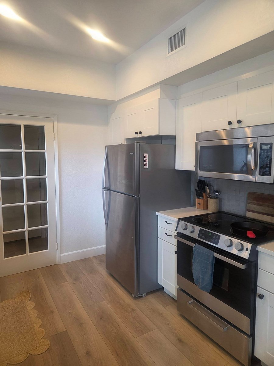 Kitchen with full sized fridge and electric oven