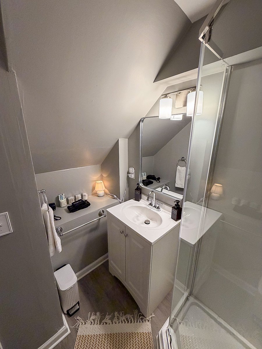 Additional bathroom shelving provides practical storage for toiletries, towels, and personal belongings during longer stays.