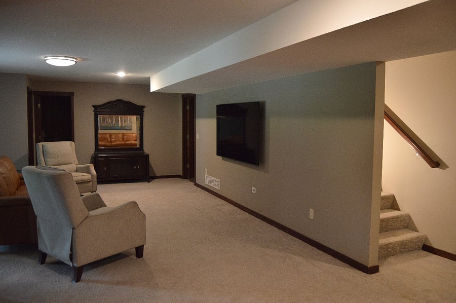 basement living room with NEW 75" smart TV stairs on the right
