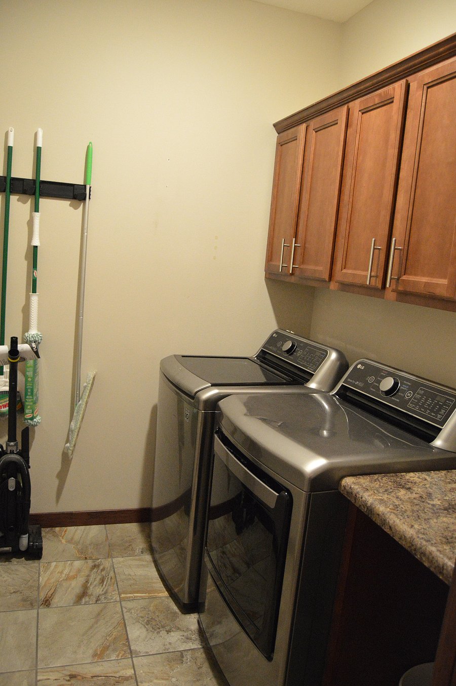 upstairs laundry room between garage entrance and kitchen