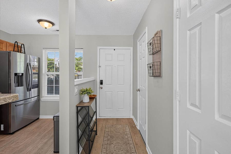 Entryway with powder room and pantry in hall.
