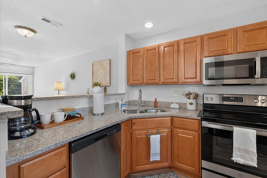 Kitchen features newer appliances and granite countertops