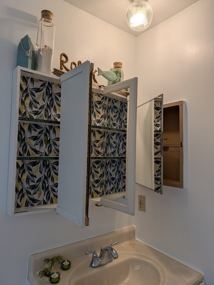 Medicine cabinet and vanity storage in bathroom.