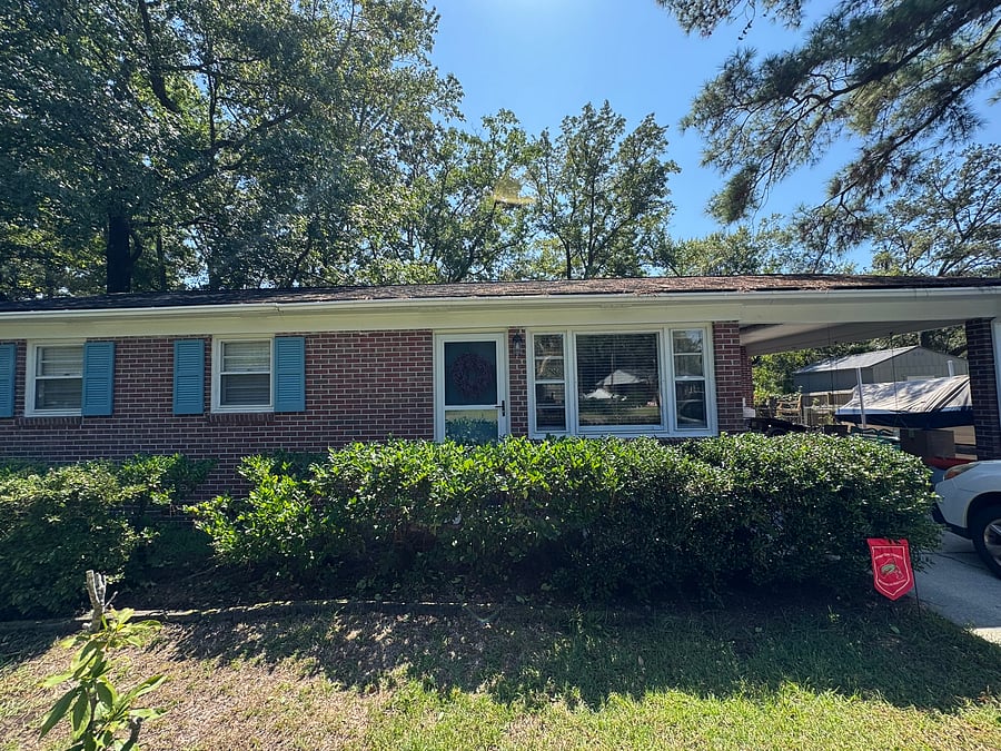 The front yard is sizeable and features privacy hedges, a comfortable bench, and a Little Free Library! Lots of parking, and covered parking is available under the carport.