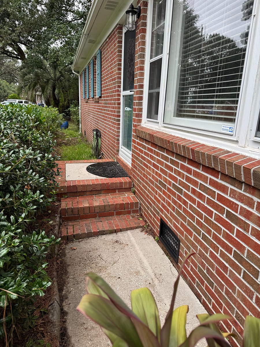 Front door has three steps and opens into the living room.