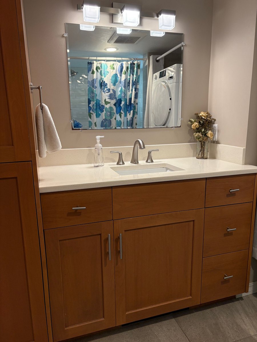 Bathroom includes shower stall with bench