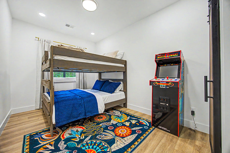 Queen over Queen bunk bed with in room arcade gaming machine. Has Jack and Jill bathroom and it's own walk in closet