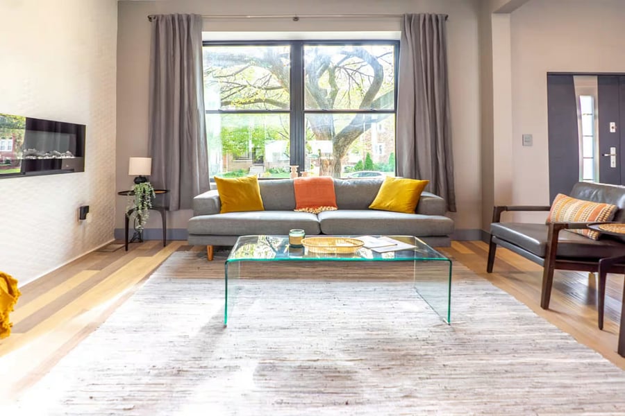 Step through the open front door into a bright hallway with modern stairs.