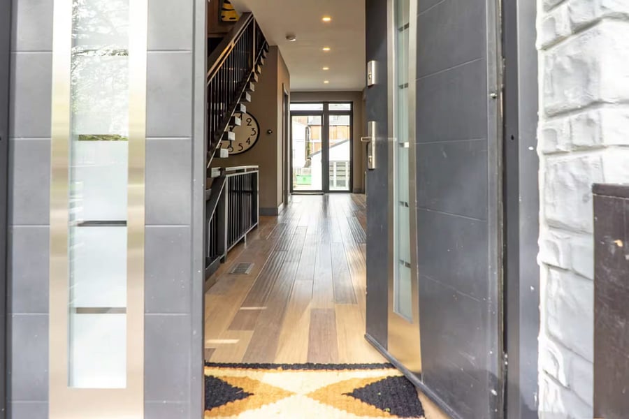 From the entry, see the open living area, kitchen island, and rear glass doors.